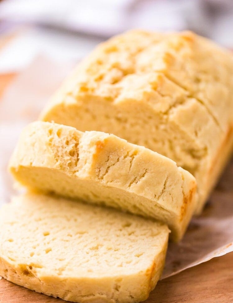 Beer Bread loaf sliced on a wood cutting board