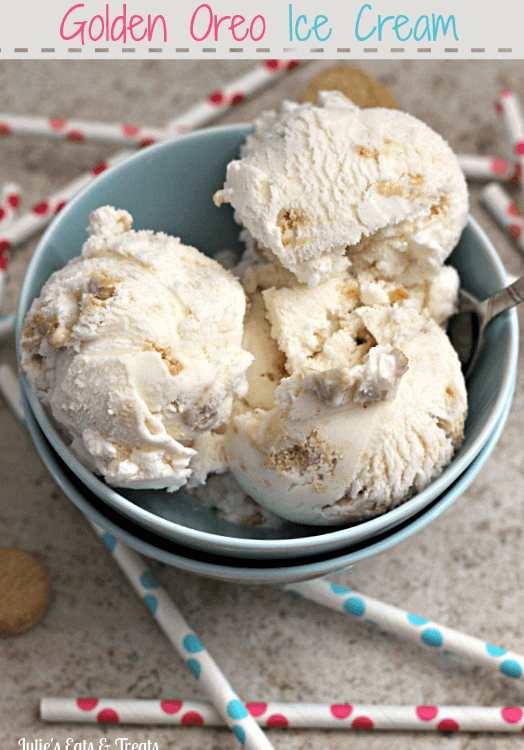 A bowl of golden Oreo ice cream with a spoon in it sitting on a counter with polka dot straws