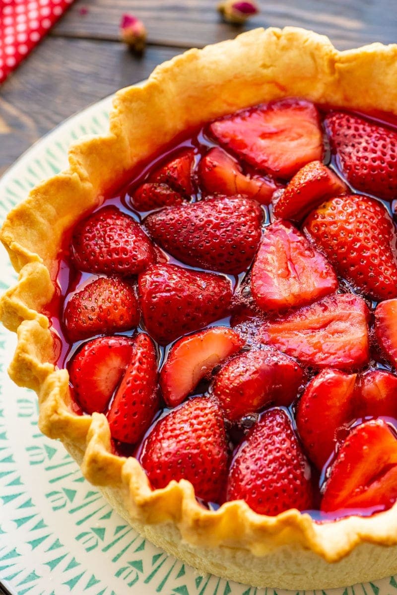 Strawberry Pie on white and green platter with red napkin in background