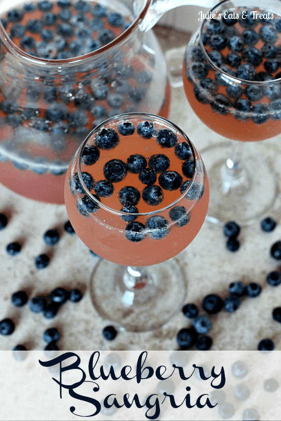Blueberry Sangria ~ You won't be able to stop with just one of these fabulous drinks! A mixture of Chardonnay, Pink Lemonade, Brandy, Sprite and Blueberries will have you coming back for more! via www.julieseatsandtreats.com