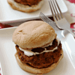 Two buffalo chicken ranch burgers on white square plate with two forks