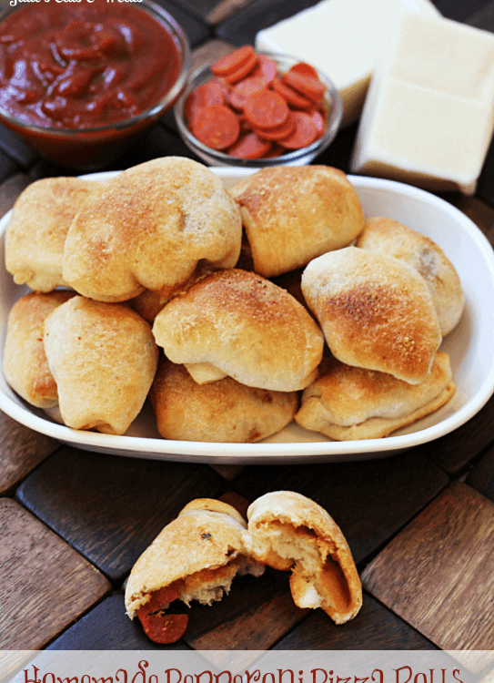 Homemade pepperoni pizza rolls on a white plate in front of a bowl of marinara sauce, a bowl of pepperoni, and some cheese