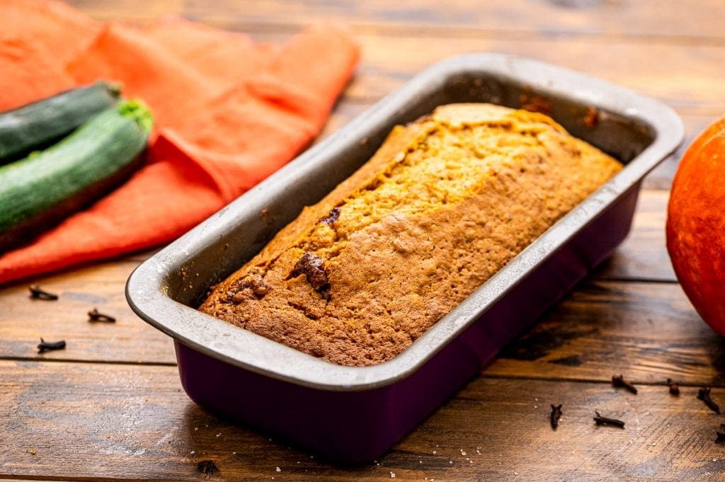 Pumpkin Zucchini Bread Loaf in pan on a wooden background