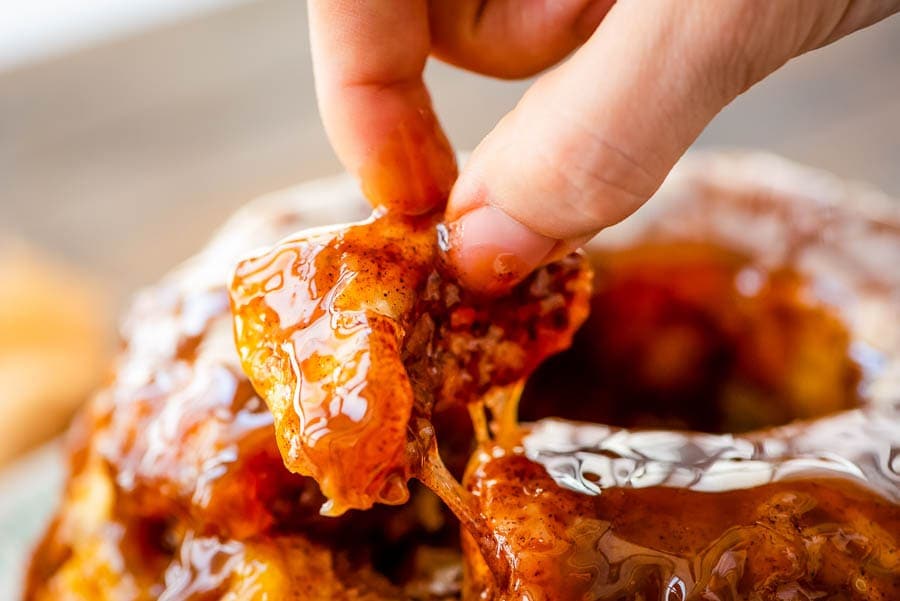 Hand taking a piece of Apple Monkey Bread