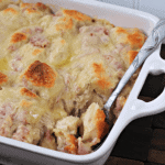 White baking dish of cordon bleu bubble up with a spoon