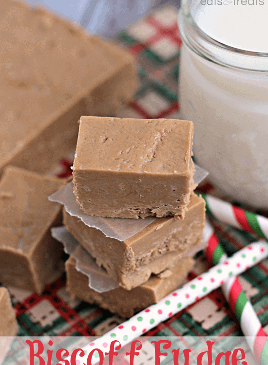 Three biscoff fudge pieces stacked on a green and red tray with a glass of milk