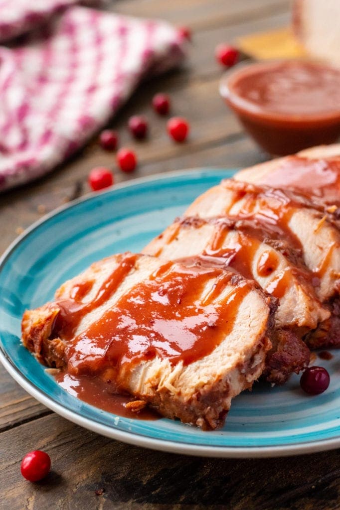 Slow Cooker Pork Loin on plate with cranberry sauce