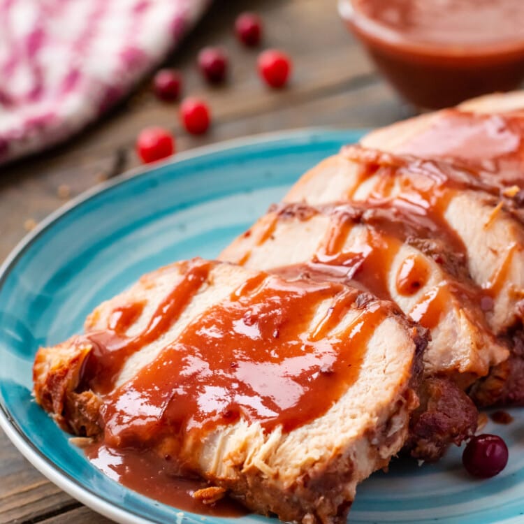 Slow Cooker Pork Loin on plate with cranberry sauce