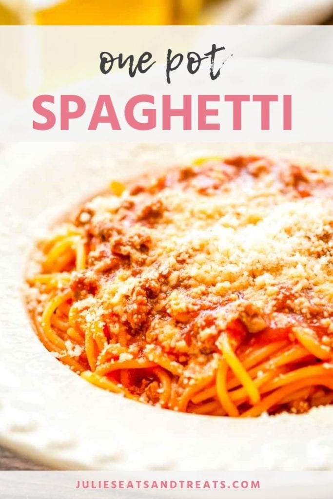 Spaghetti in a white bowl topped with parmesan