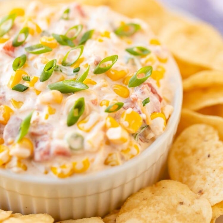 Corn Dip Recipe in white bowl on platter of tortilla chips