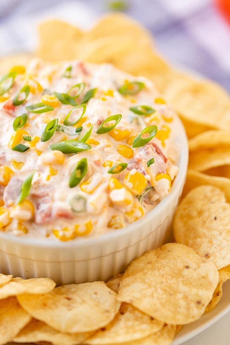 Corn Dip Recipe in white bowl on platter of tortilla chips