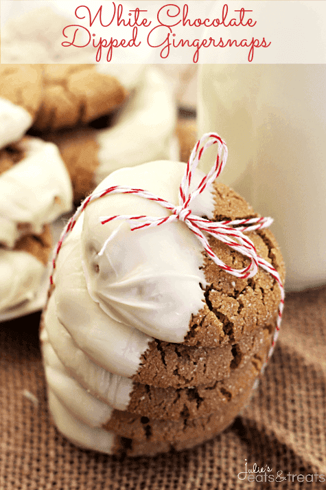 Stack of five white chocolate dipped gingersnaps tied together with red and white string on a burlap place mat with a glass of milk