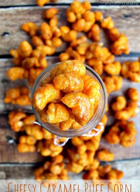 Glass jar of cheesy caramel puff corn spilling out onto the table