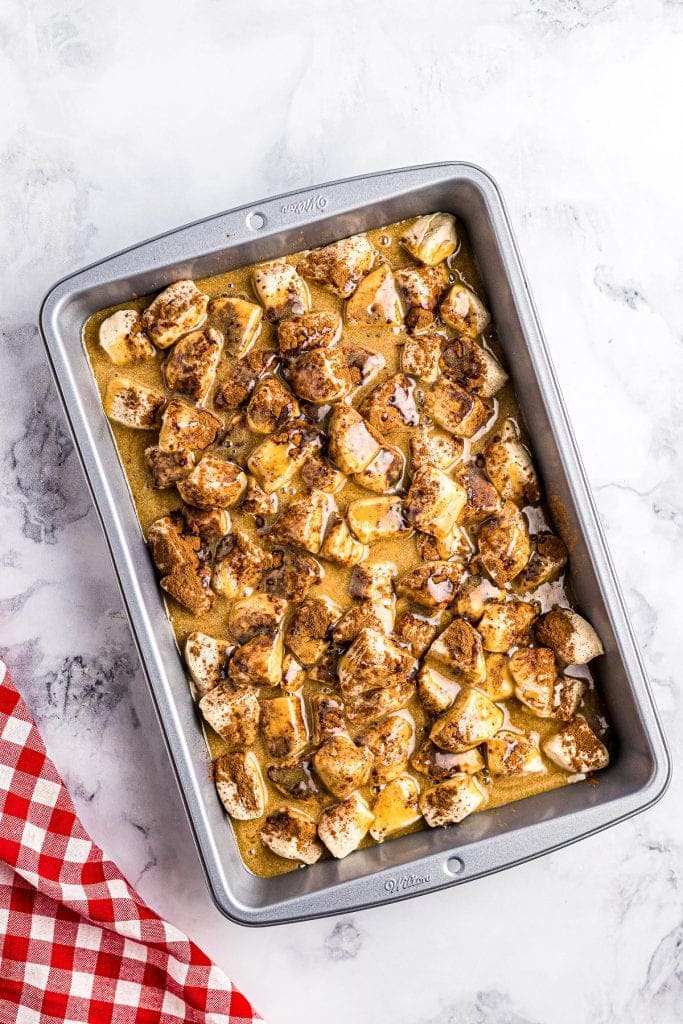 Cake pan with biscuit pieces covered in caramel sauce