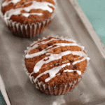 Three skinny coffee cake muffins in a row on a silver tray