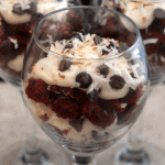Three wine glasses of red velvet cake trifle
