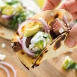 Hand holding a grilled steak taco