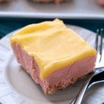 Piece of frozen dessert on a white plate with two forks