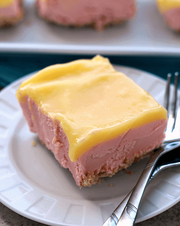 Piece of frozen dessert on a white plate with two forks