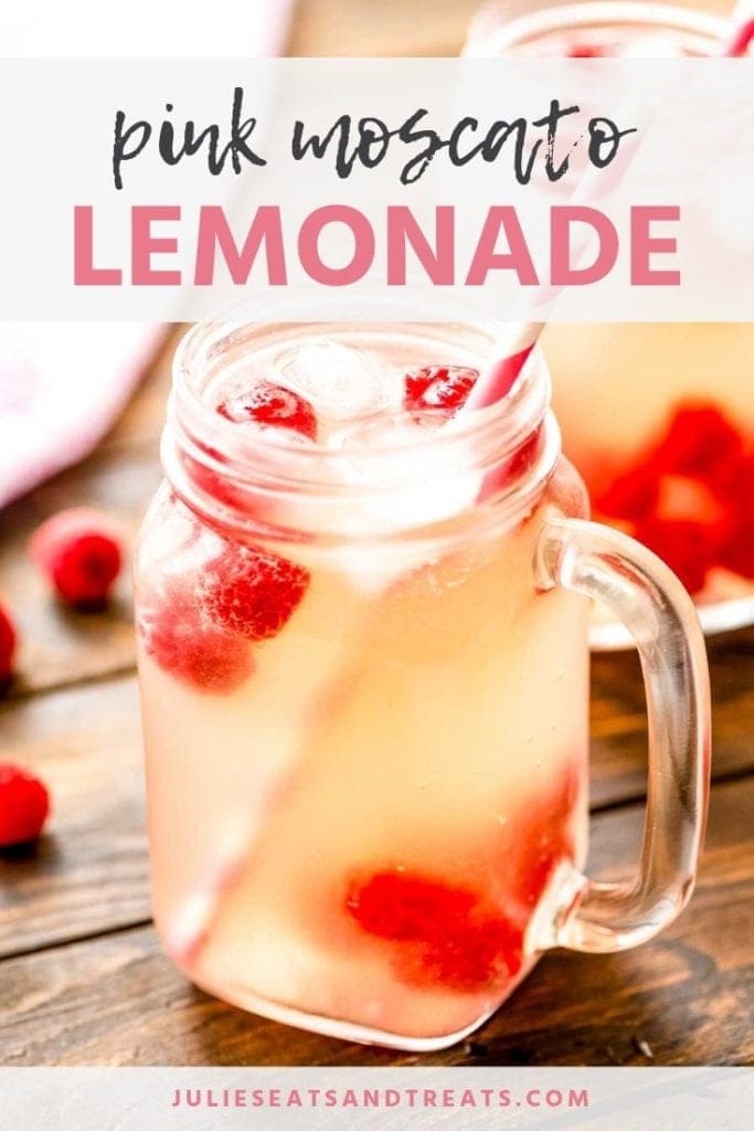 Glass mason jar mug of pink moscato lemonade with raspberries