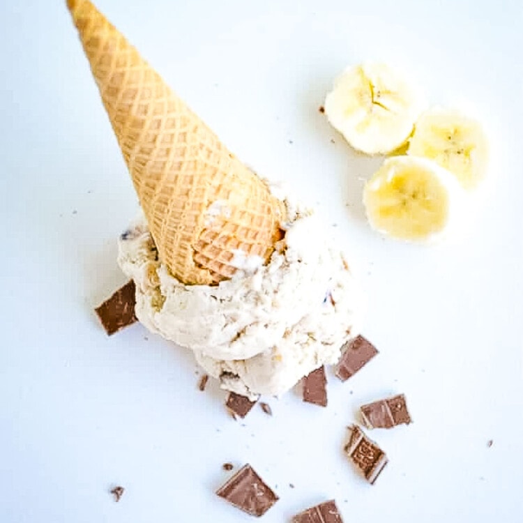 banana split ice cream cone upside down with chocolate chunks and banana slices