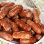 Crock pot kickin' cheesy beer smokies in a white bowl