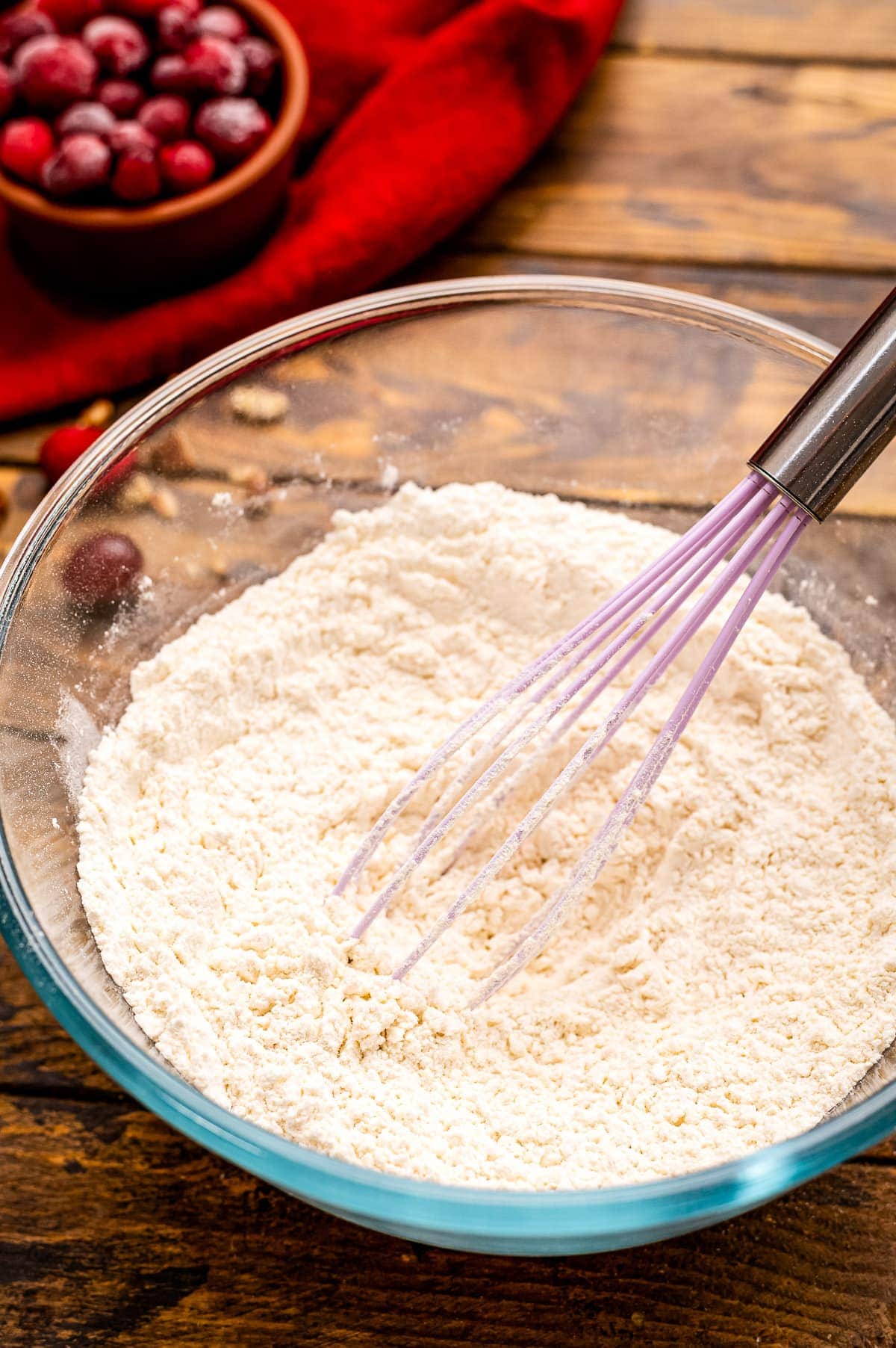 Whisk in glass bowl with dry ingredients for muffins