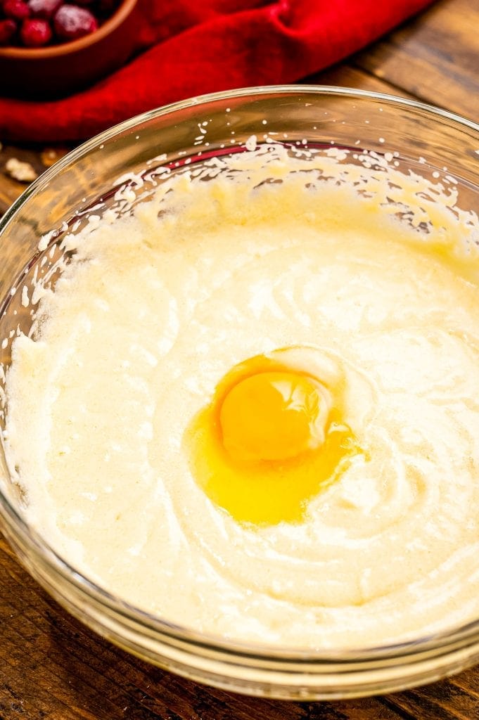 Batter in glass bowl creamed together with an egg on top.