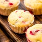 Cream Cheese Cranberry Muffins on wooden cutting board