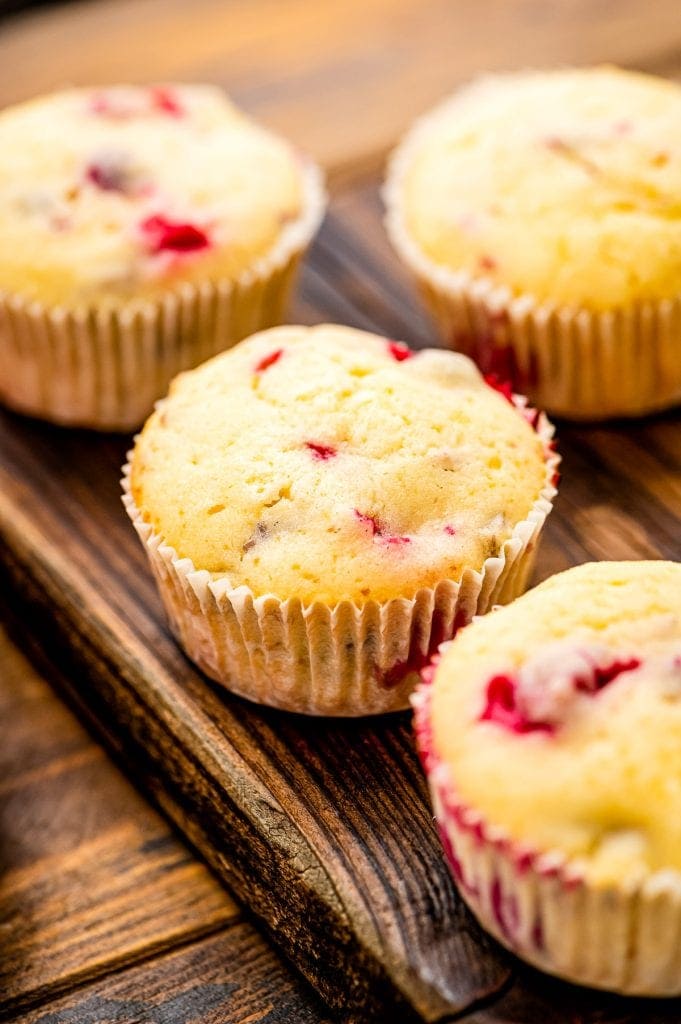 Cream Cheese Cranberry Muffins on wooden cutting board