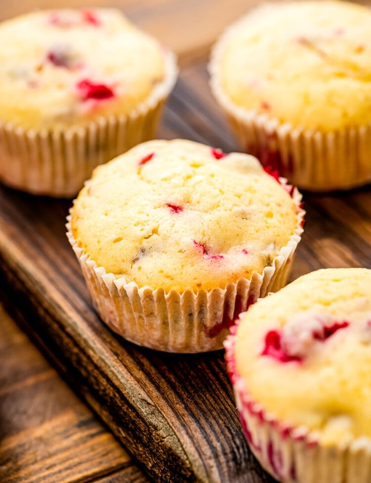 Cream Cheese Cranberry Muffins on wooden cutting board