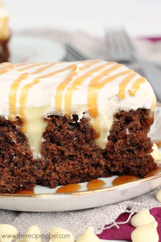 White Chocolate Gingerbread Poke Cake: moist spice cake filled with creamy white chocolate pudding and topped with whipped cream. The perfect dessert for the holidays!