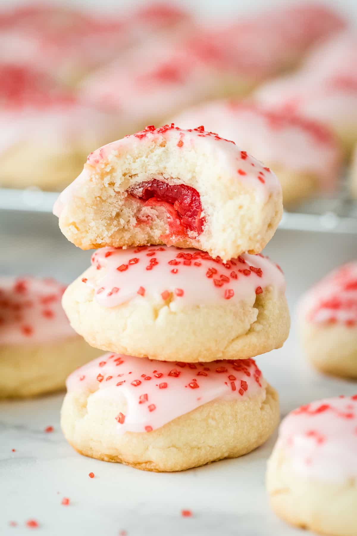 Almond Sugar Cookies stacked with top one cut open