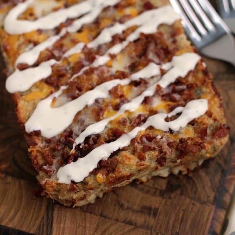 Loaf of chicken bacon ranch meatloaf on a wood board with two forks