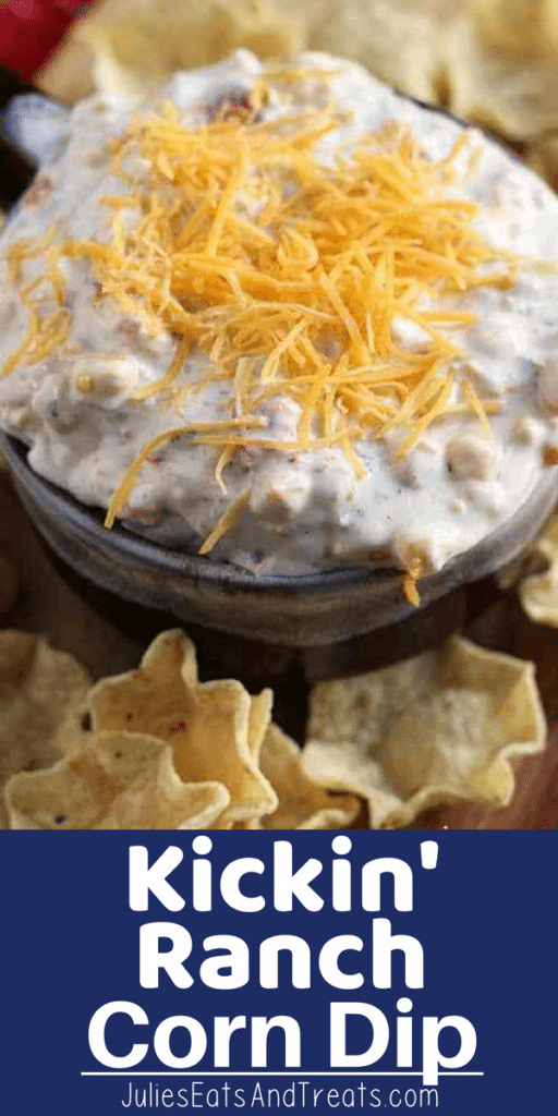 Kickin' ranch corn dip in a bowl topped with shredded cheese and surrounded by tortilla chips
