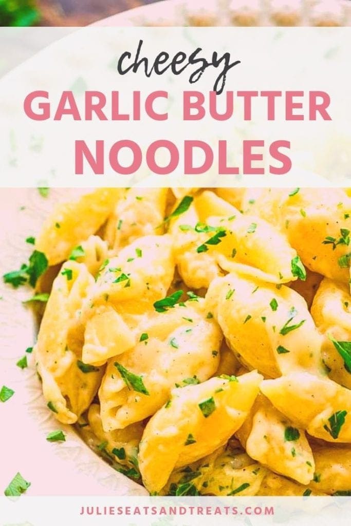 Cheesy garlic butter noodles in a white bowl topped with parsley