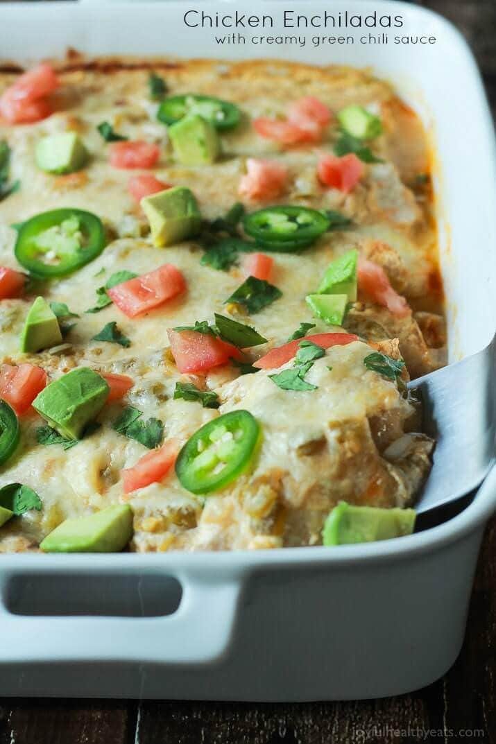 Chicken Enchiladas topped with a Creamy Green Chili Sauce made with Greek Yogurt and spicy green chilis! An easy weeknight meal that will beat going out to eat any day of the week!