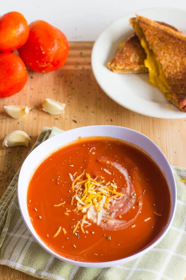 This Slow Cooker Tomato Basil Soup is creamy, rich with flavor and perfect for spring! Throw it in the Crock Pot and it will be waiting for you when you are ready to eat!