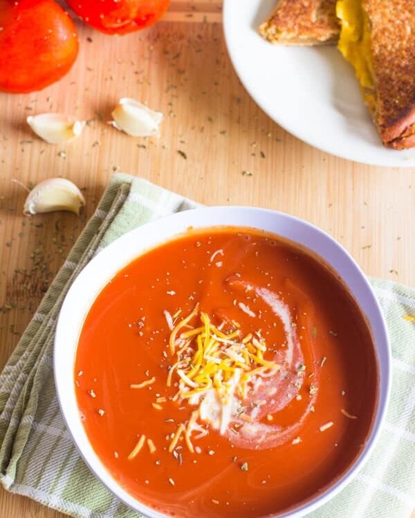 This Slow Cooker Tomato Basil Soup is creamy, rich with flavor and perfect for spring! Throw it in the Crock Pot and it will be waiting for you when you are ready to eat!