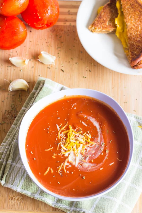 This Slow Cooker Tomato Basil Soup is creamy, rich with flavor and perfect for spring! Throw it in the Crock Pot and it will be waiting for you when you are ready to eat!