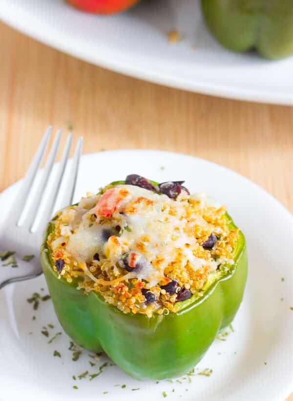 These Tex Mex Quinoa Stuffed Peppers are a healthy protein packed, delicious and easy weeknight meal for your family!