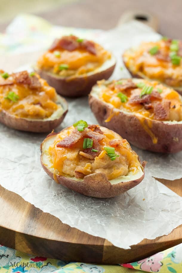 Grilled BBQ Bacon Twice Baked Potatoes: Tender potato shells stuffed with mashed potatoes flavored with barbecue sauce, bacon and cheddar cheese, and grilled to perfection! Microwaving the potatoes keeps things super easy and keeps the house cool in the summer. You can also bake them in the oven if you desire.