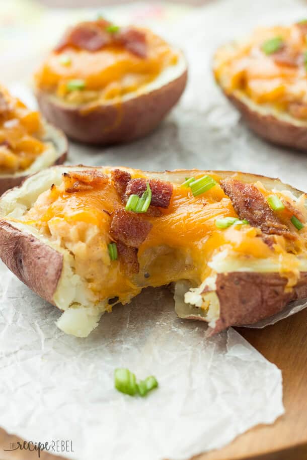 Grilled BBQ Bacon Twice Baked Potatoes: Tender potato shells stuffed with mashed potatoes flavored with barbecue sauce, bacon and cheddar cheese, and grilled to perfection! Microwaving the potatoes keeps things super easy and keeps the house cool in the summer. You can also bake them in the oven if you desire.