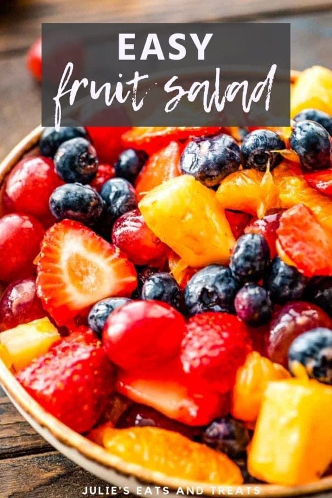 Fruit salad in a bowl on a wood board