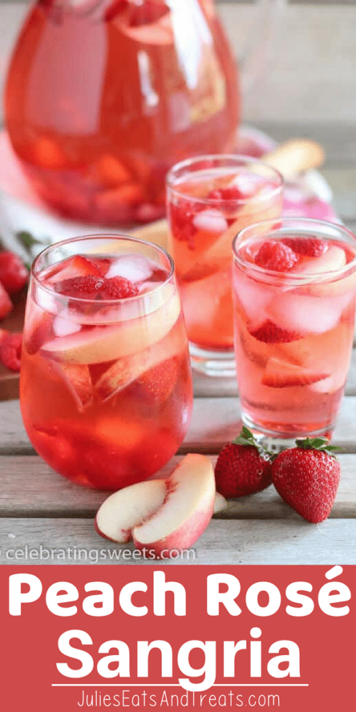 White Peach Rose Sangria in three glasses on a table with strawberries and peach slices