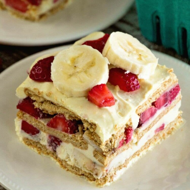 A square piece of skinny strawberry banana ice box cake on a white plate