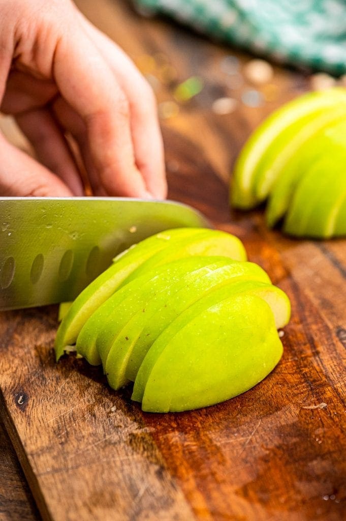 Knife thinly sliced green apple