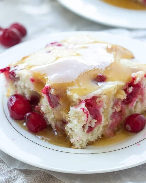 Cranberry Cake with Caramel Sauce Recipe ~ Moist vanilla cake filled with cranberries and covered in a warm caramel sauce! An elegant holiday dessert that is super easy!