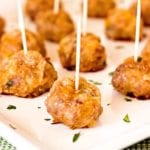 Mexican sausage balls with toothpicks in each one on a white plate