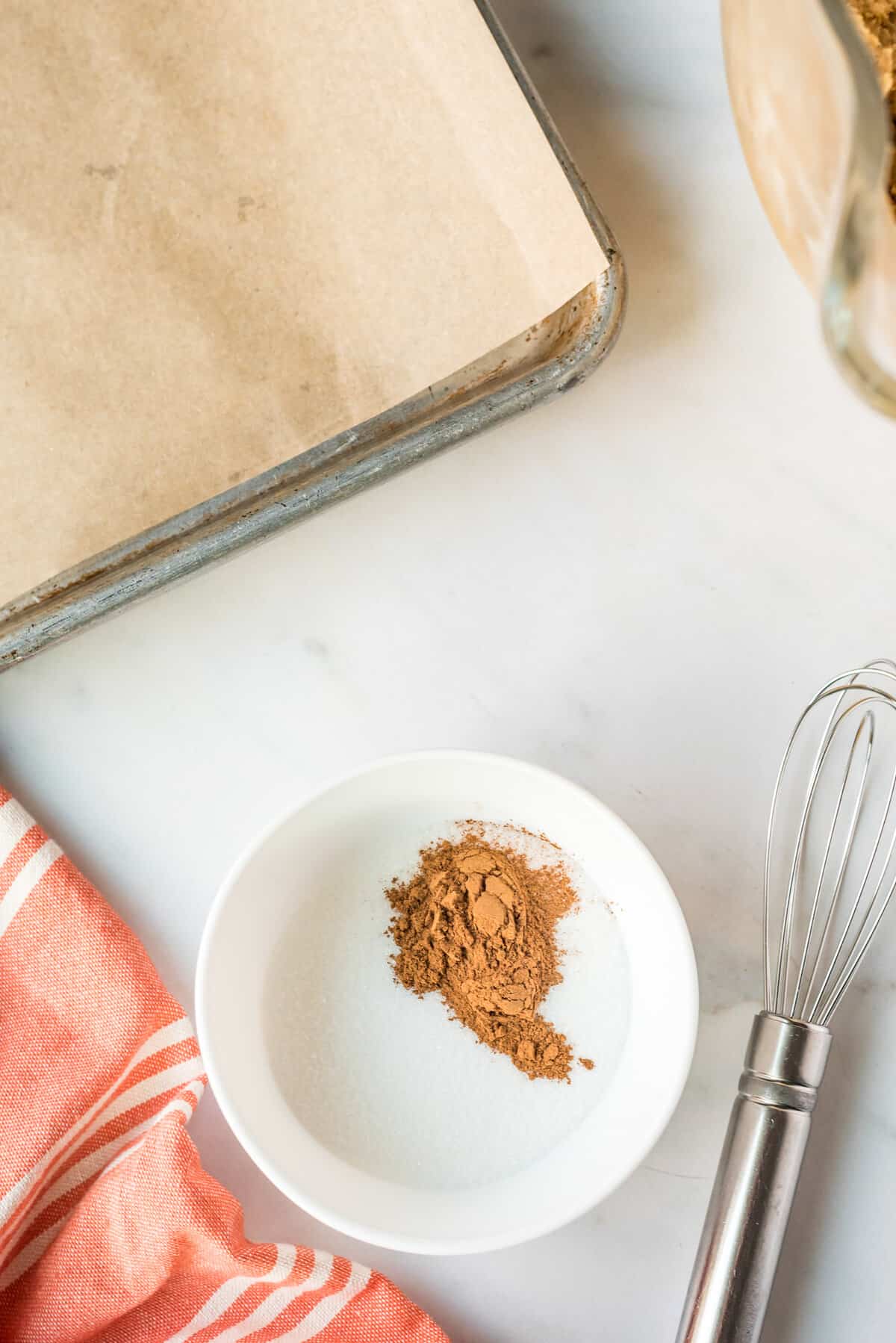 Cinnamon and sugar in white bowl